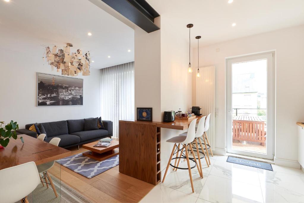 a living room with a couch and a table at CityStudios in Luxembourg