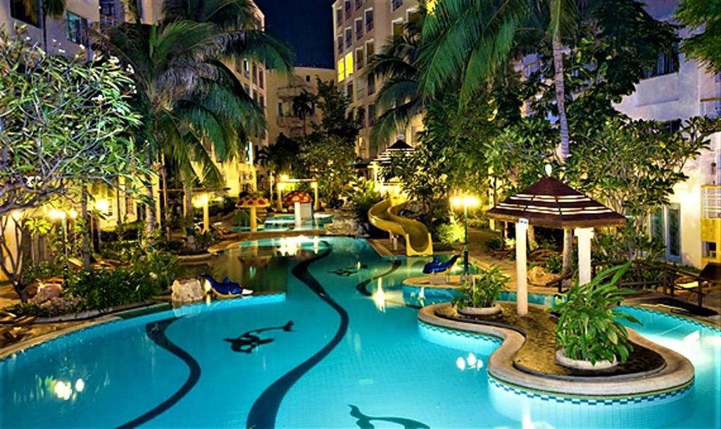 a swimming pool at a resort at night at Shanty of HinNam Condominium in Hua Hin
