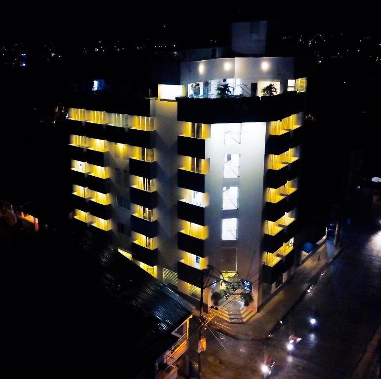 a tall building with lights on it at night at Hotel Interpacific in Quibdó