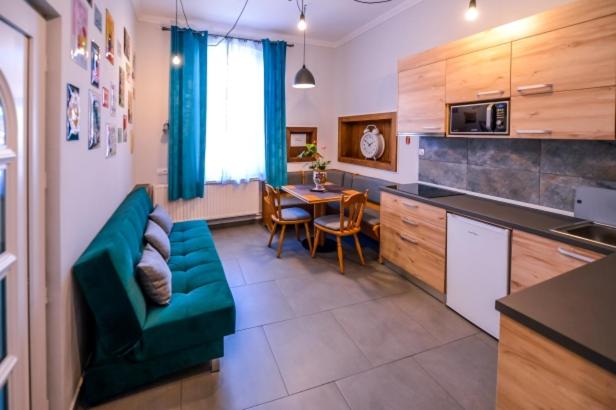 a kitchen with a couch and a table in a room at ATRIUM 24 Studio in Sighişoara