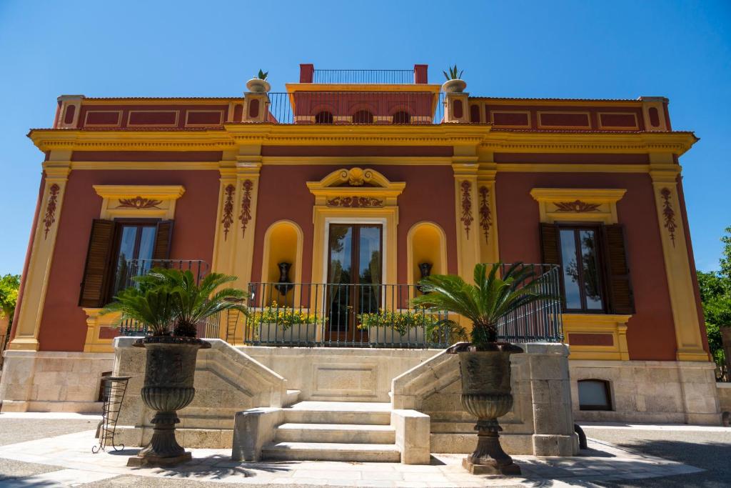 a building with a staircase in front of it at Hotel Terranobile Metaresort in Bari