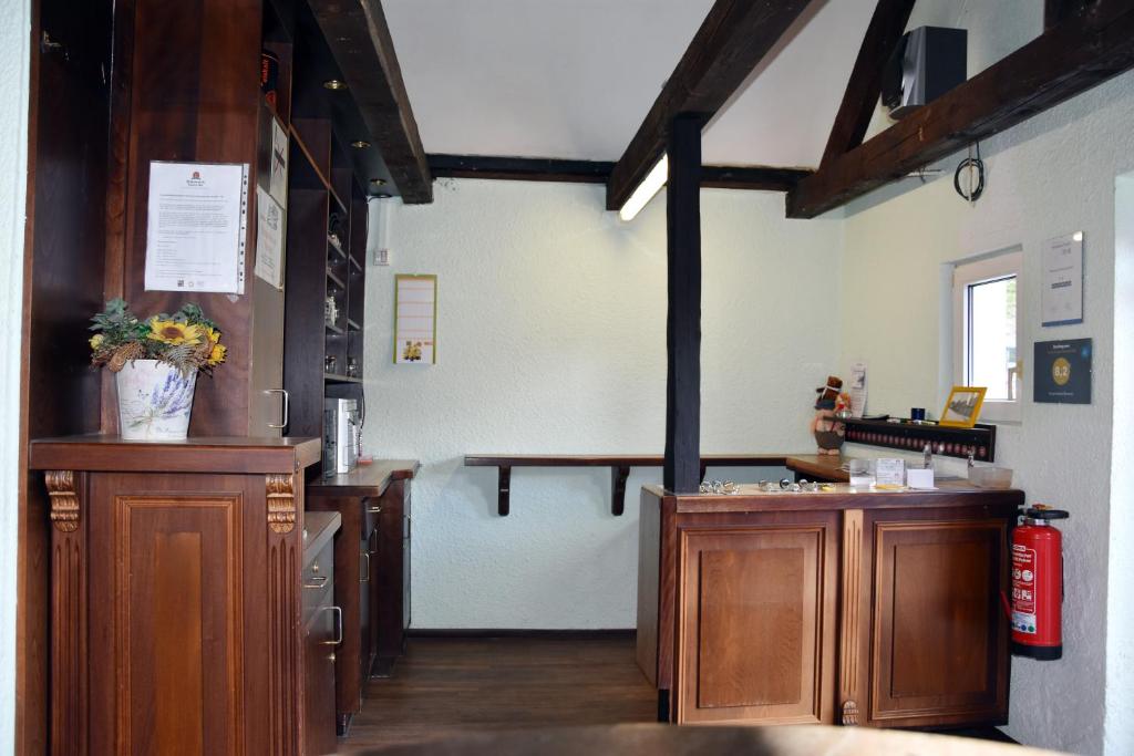 a kitchen with wooden cabinets and a table in a room at Kutscherhof Broock in Broock