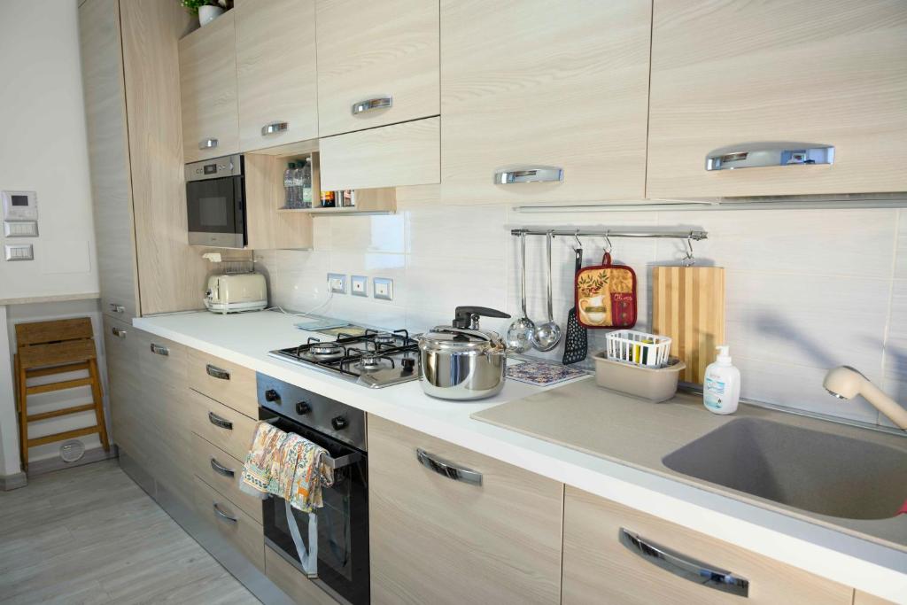 a kitchen with a sink and a stove top oven at intero appartamento con giardino e colazione Dario in Parma