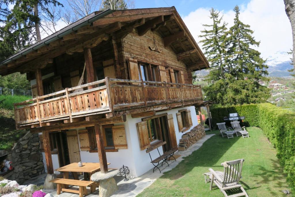 a log cabin with a porch and a deck at Mayen de l'Art d Vivre in Crans-Montana