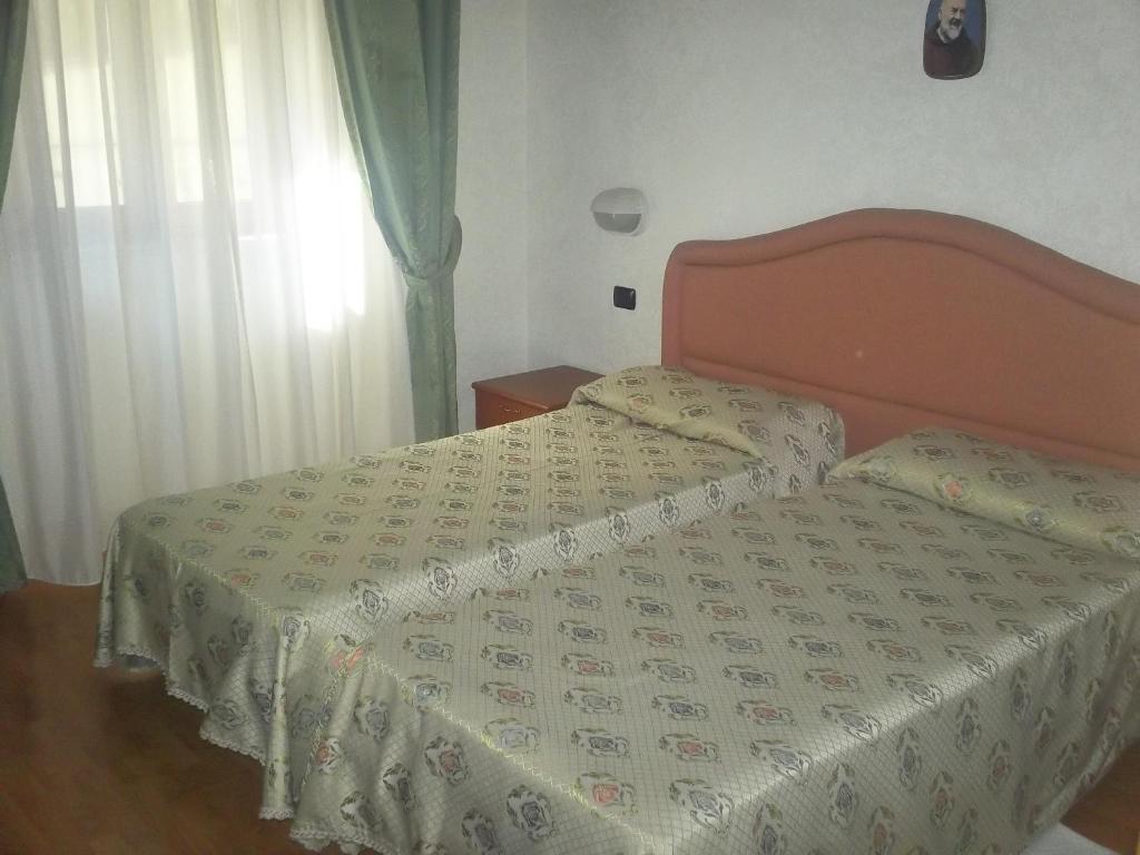 Postel nebo postele na pokoji v ubytování Hotel Gaggiano