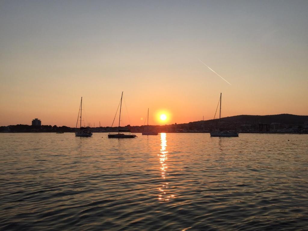 a group of boats in the water at sunset at Villa Chiara in Vodice