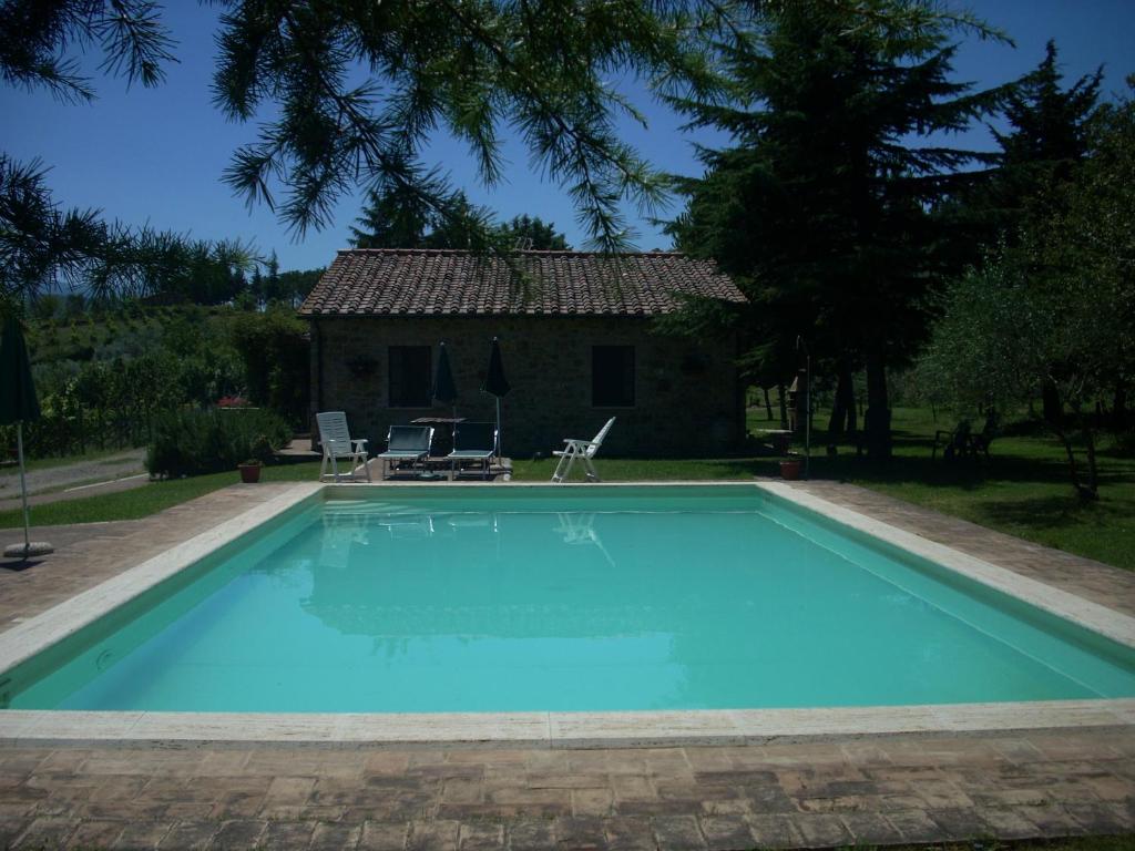 a swimming pool in front of a house at Agriturismo Il Pratone in Castiglione dʼOrcia