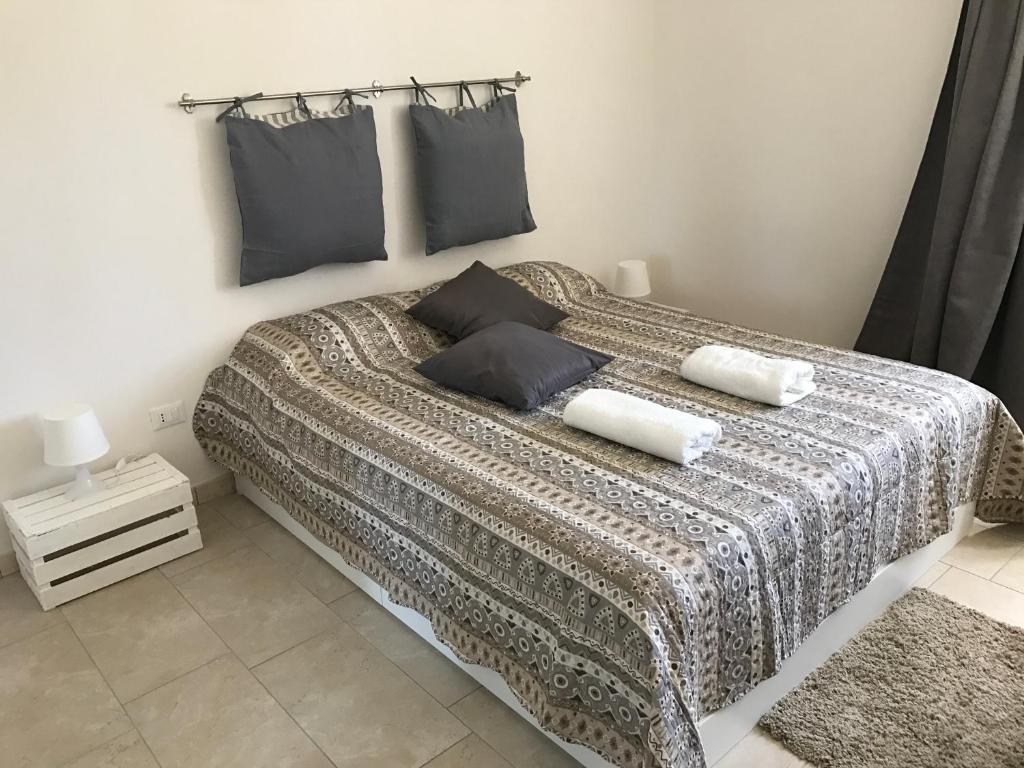 a bedroom with a large bed with two pillows at Zibi&Bibbo in Marsala