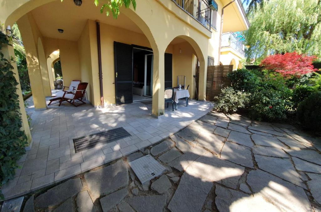 un patio al aire libre con sillas y un edificio en ROSE'S GARDEN - UN ANGOLO DI QUIETE, en Pino Torinese