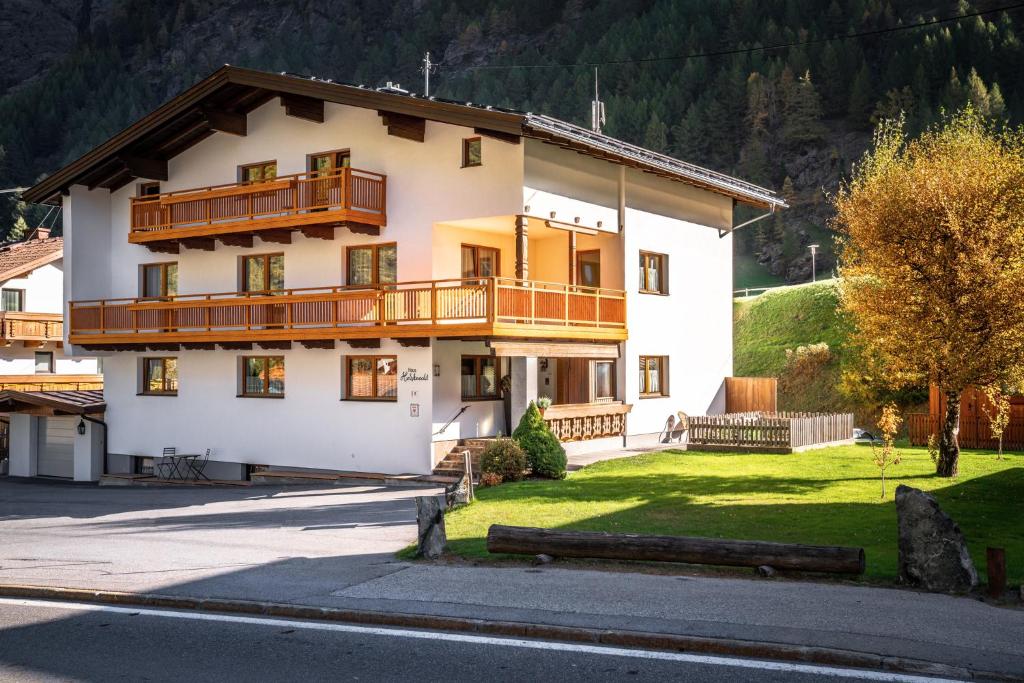 a large white building with a balcony on the side of it at Appartement Holzknecht in Sölden