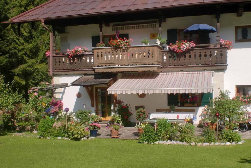 a house with a balcony with flowers on it at Schönfeldjoch in Bayrischzell