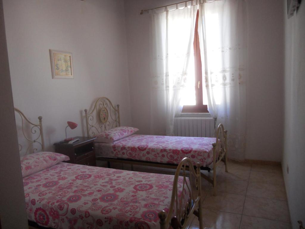 Postel nebo postele na pokoji v ubytování Guest House Efisio