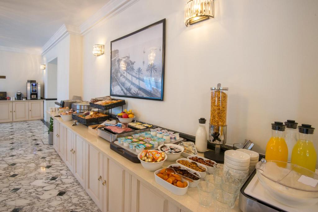 a buffet line with breakfast foods and drinks at Hotel Carlton in Beaulieu-sur-Mer