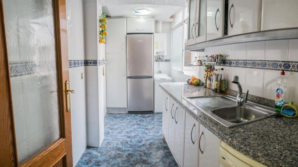 a kitchen with a sink and a refrigerator at Very best flat ust 800m Postiguet-Beach in Alicante