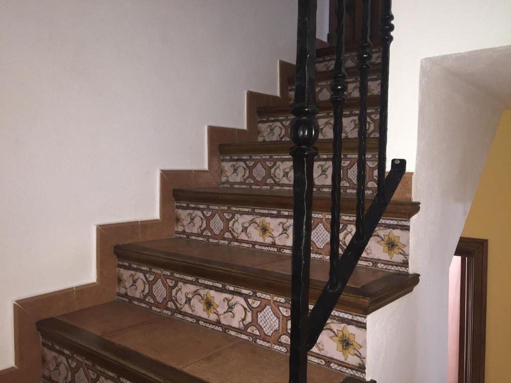 a set of stairs with a wrought iron railing at El Corral de Dolores in El Bosque