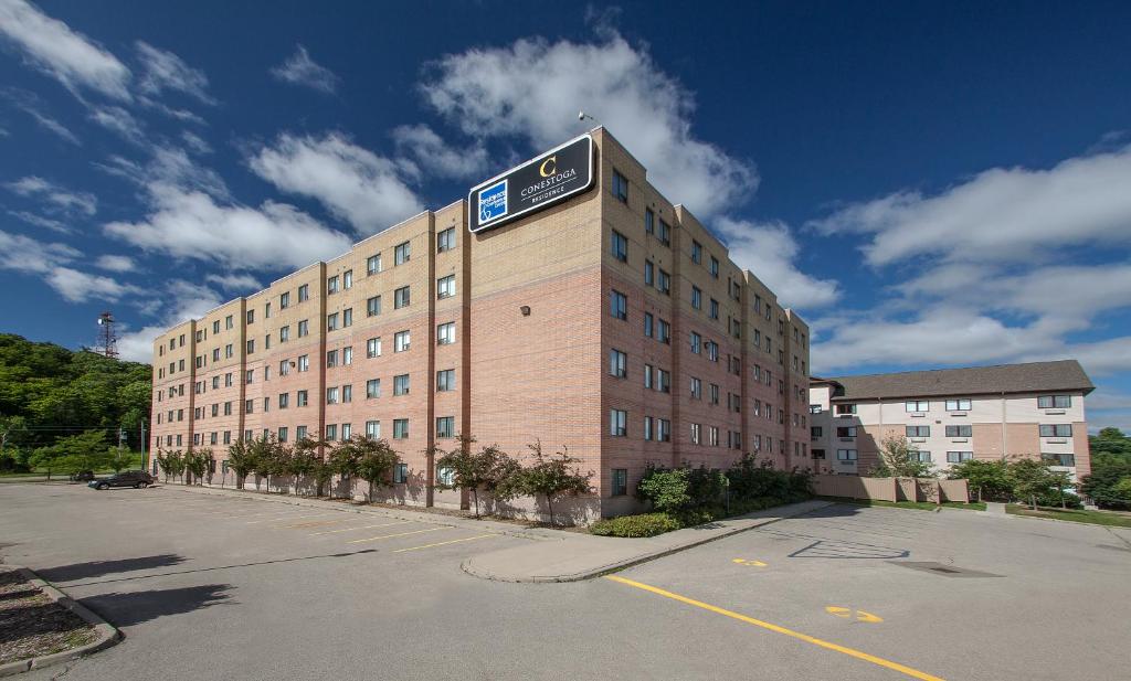 a large building with a sign on the top of it at Residence & Conference Centre - Kitchener-Waterloo in Kitchener