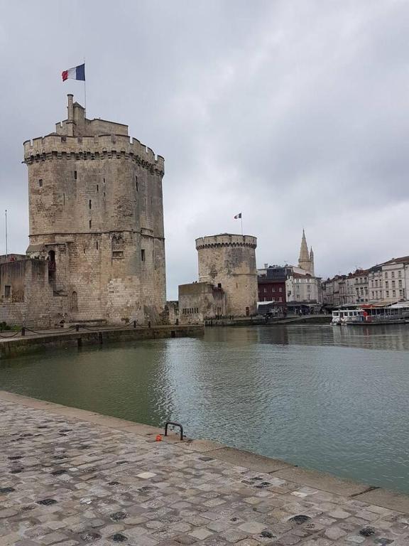 an old castle sitting next to a body of water at Appartement Ré (4 personnes) in Châtelaillon-Plage