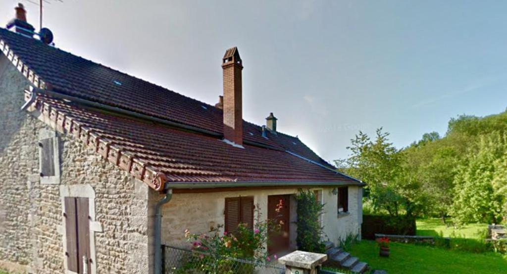 an old stone house with a chimney on top of it at Les pommiers in Bouilland