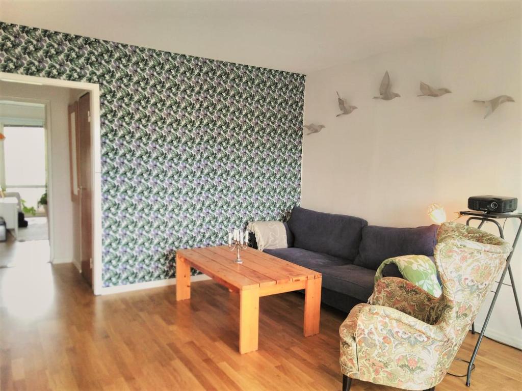 a living room with a couch and a table at Spacious flat with balcony in central & hip area in Gothenburg