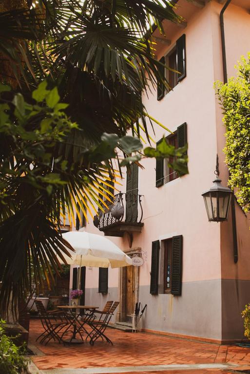 a table with an umbrella next to a building at Il Villino in Lucca