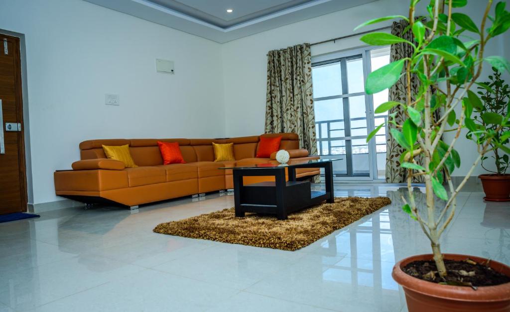 Cloud9Homes Serviced Apartments في حيدر أباد: غرفة معيشة مع أريكة وطاولة