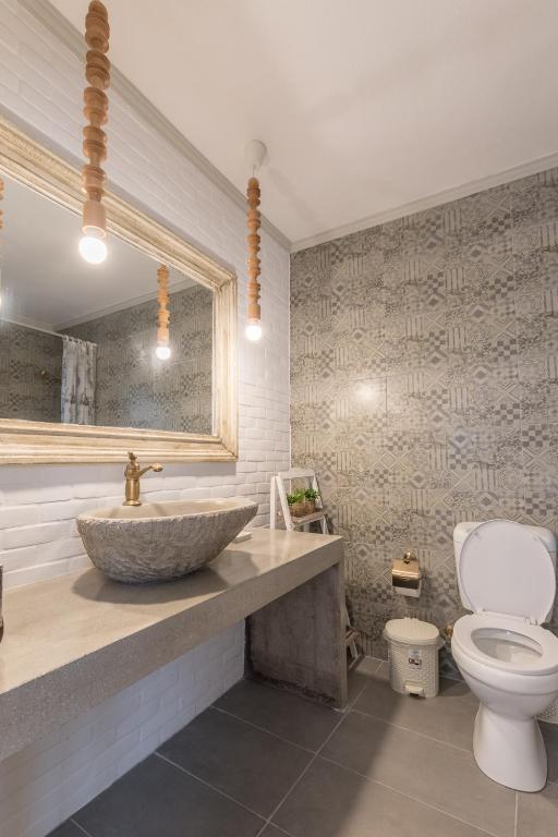 a bathroom with a sink and a toilet at Olympus Studios in Malia