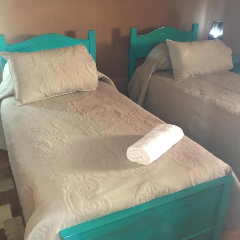 Postel nebo postele na pokoji v ubytování Hostal Katari