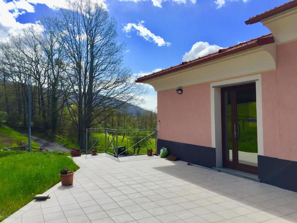 a house with a patio with a view of a field at Le Pianelle in Varese Ligure