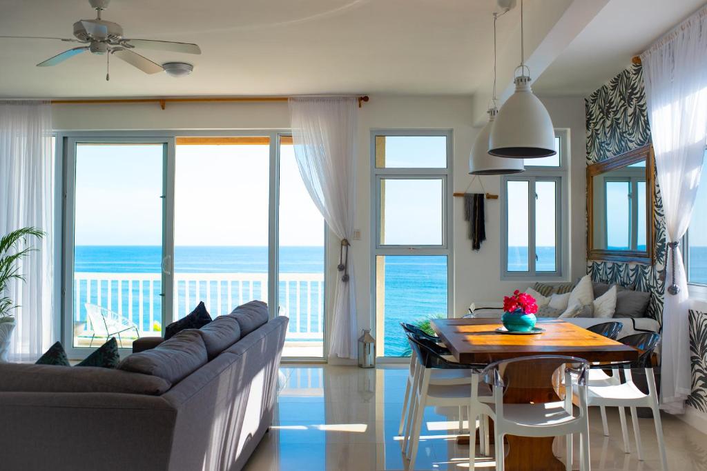 a living room with a couch and a table at Ocho Rios Penthouse at Whispering Seas in Ocho Rios