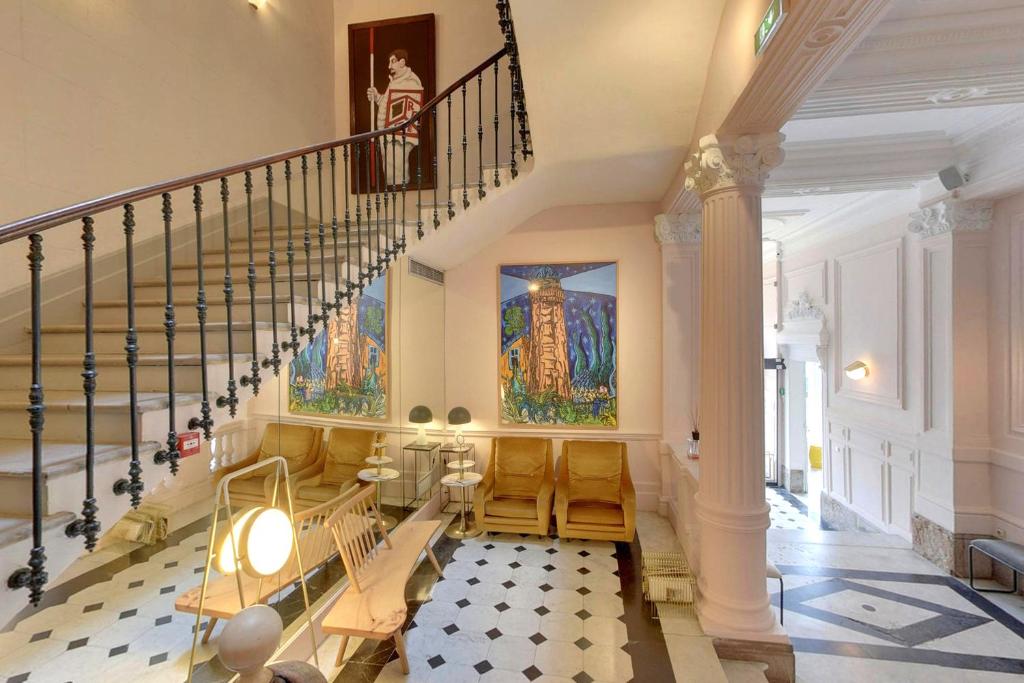 a staircase in a building with a stair case at Hôtel L'orque Bleue in Sète