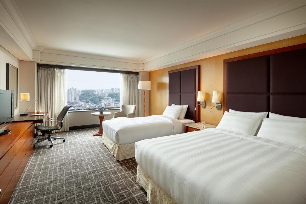Postel nebo postele na pokoji v ubytování Lotte Hotel Busan