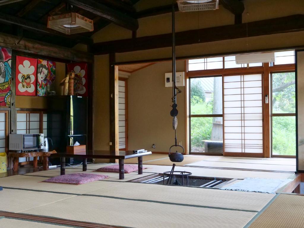 a room with a table and some windows at 民宿たきた館 guest house TAKITA-KAN in Iwaki