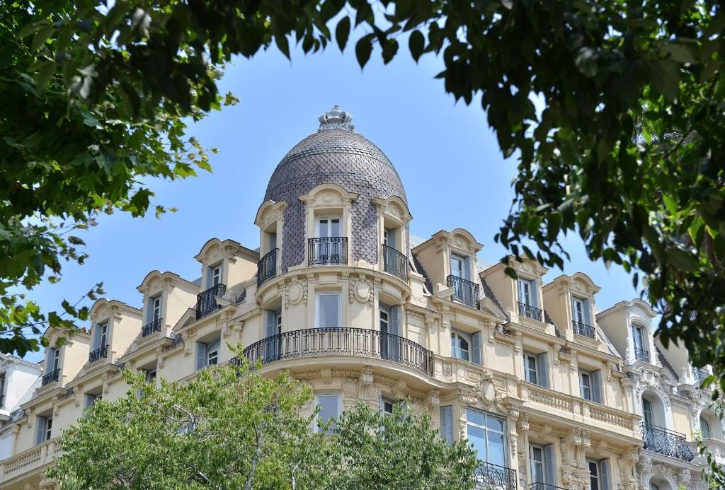 a building with a dome on top of it at Hotel La Villa Nice Victor Hugo in Nice