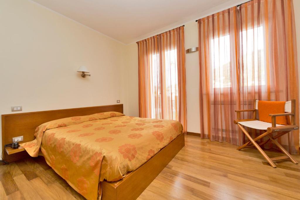 Postel nebo postele na pokoji v ubytování Oasi Hotel