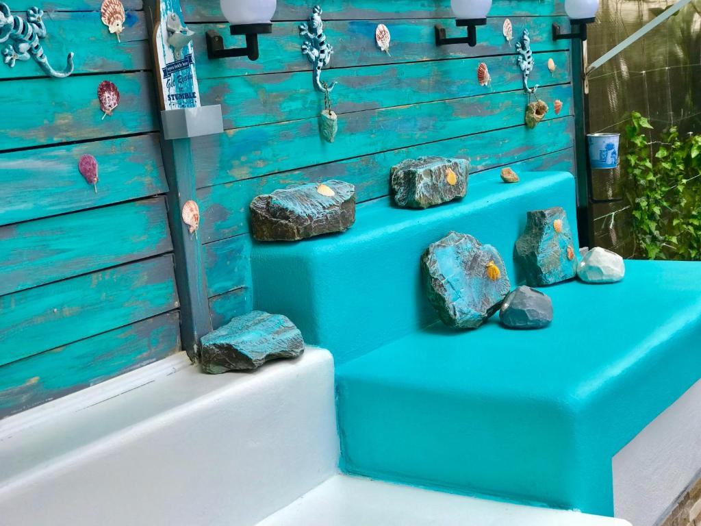 a display of rocks on a blue stairs at Arcadia Apartament Mamaia Nord in Mamaia Sat/Năvodari