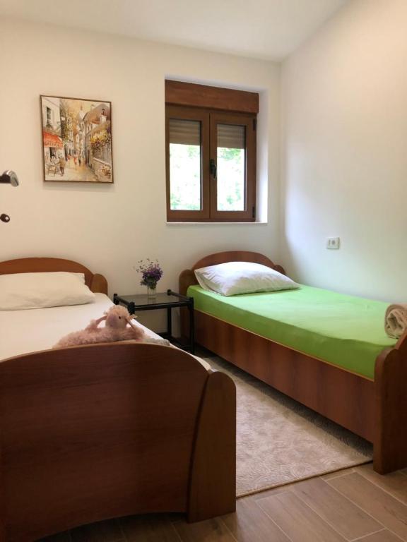 Postel nebo postele na pokoji v ubytování Apartments Villa Čučuk