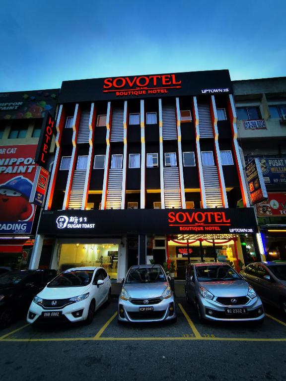 three cars parked in a parking lot in front of a building at Sovotel@Uptown 28 in Petaling Jaya
