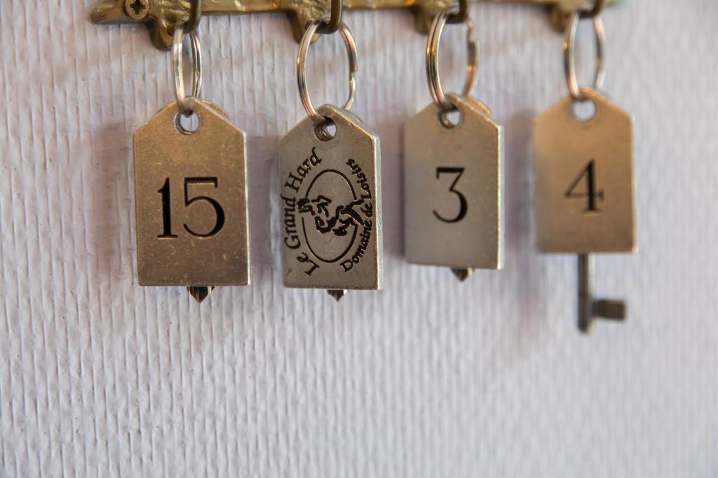 a bunch of tags hanging on a wall at Domaine Utah Beach - Le Grand Hard in Sainte-Marie-du-Mont