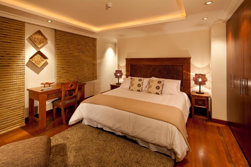 Un pat sau paturi într-o cameră la Ikala Quito Hotel