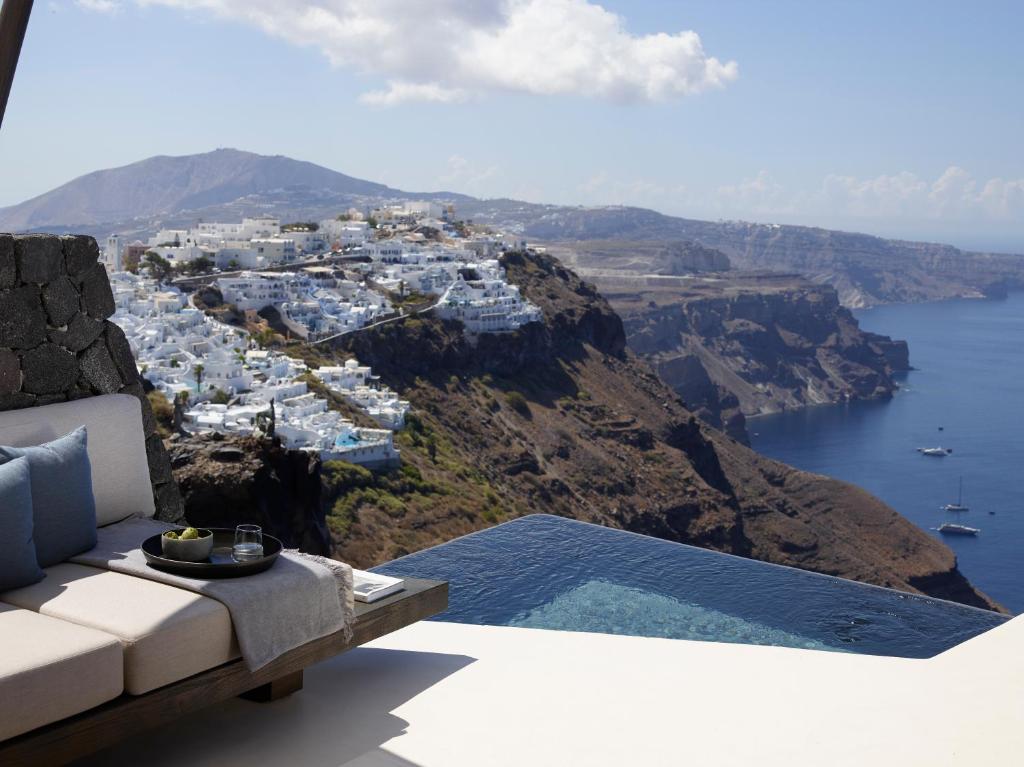 a room with a view of a town on a mountain at Vora in Imerovigli