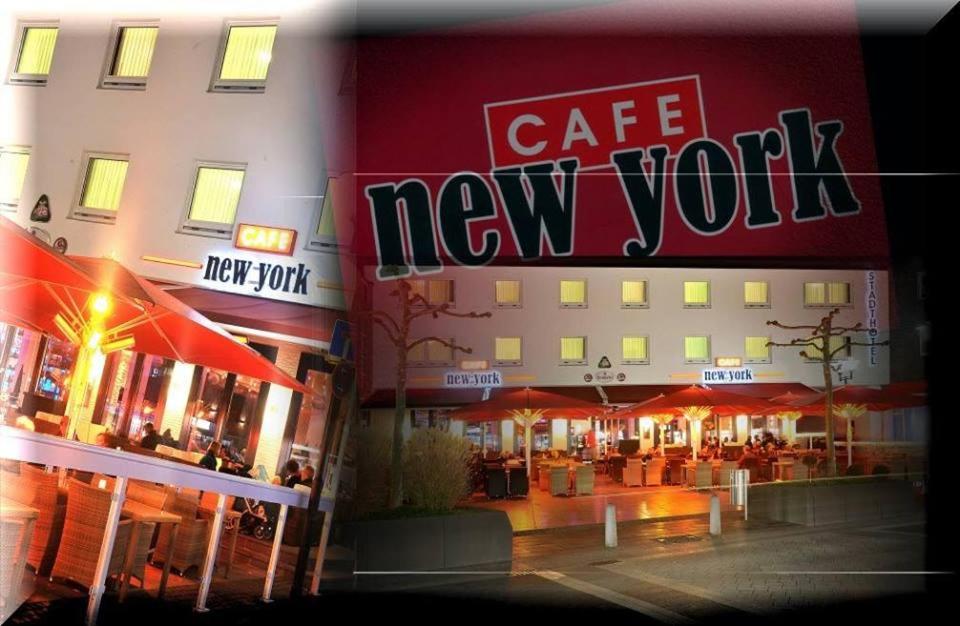 a building with a cafe new york sign on it at Stadthotel Langenfeld in Langenfeld