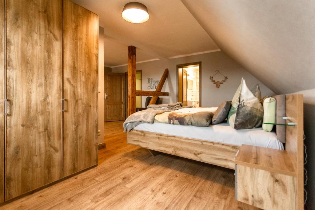 a bedroom with a large bed in a attic at Gasthof Obere Mühle in Blankenburg