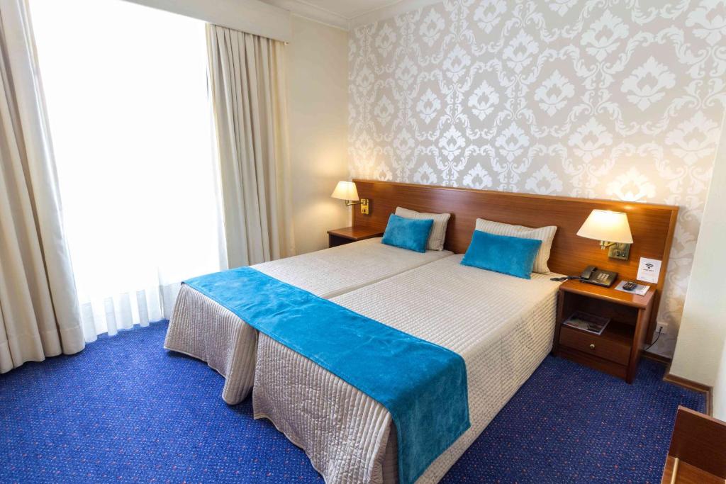 Uma cama ou camas num quarto em Hotel Eurosol Gouveia