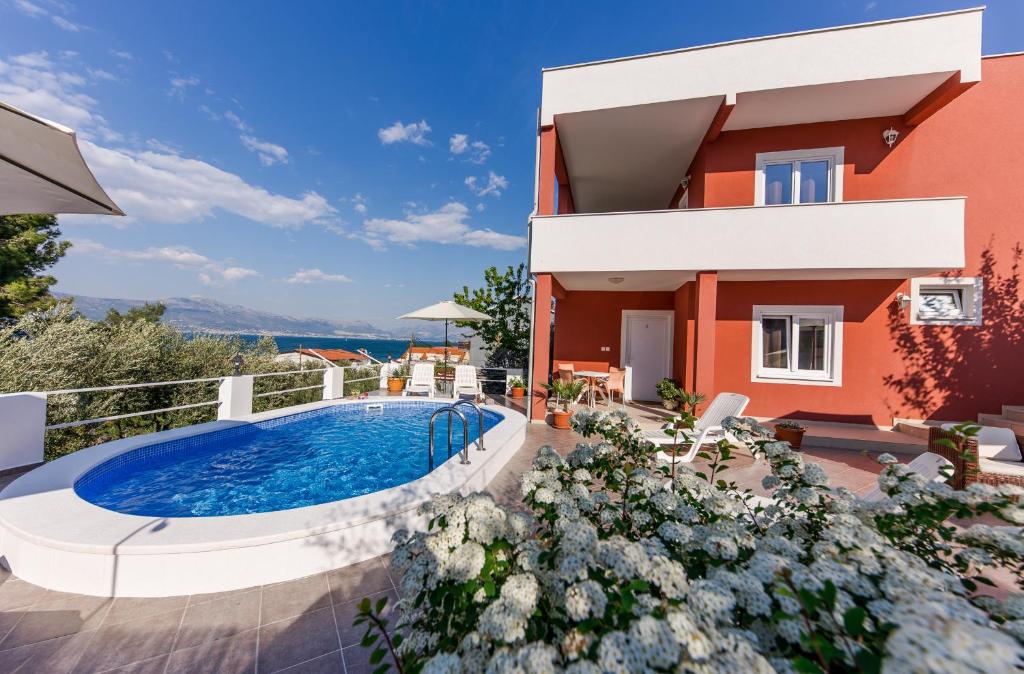 a villa with a swimming pool and a house at Holiday Villa Nostra in Trogir
