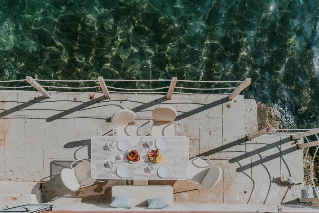 a table and chairs with a view of the ocean at Luxury Seafront Palazzo in Rovinj