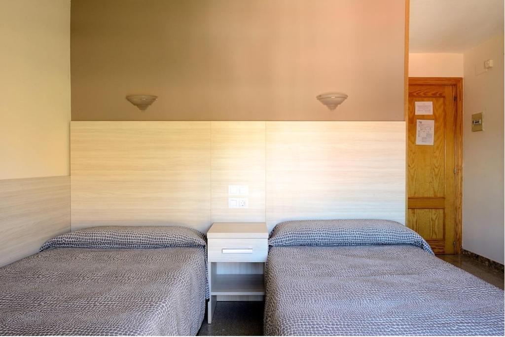 Cama o camas de una habitación en Hostal Las Rumbas