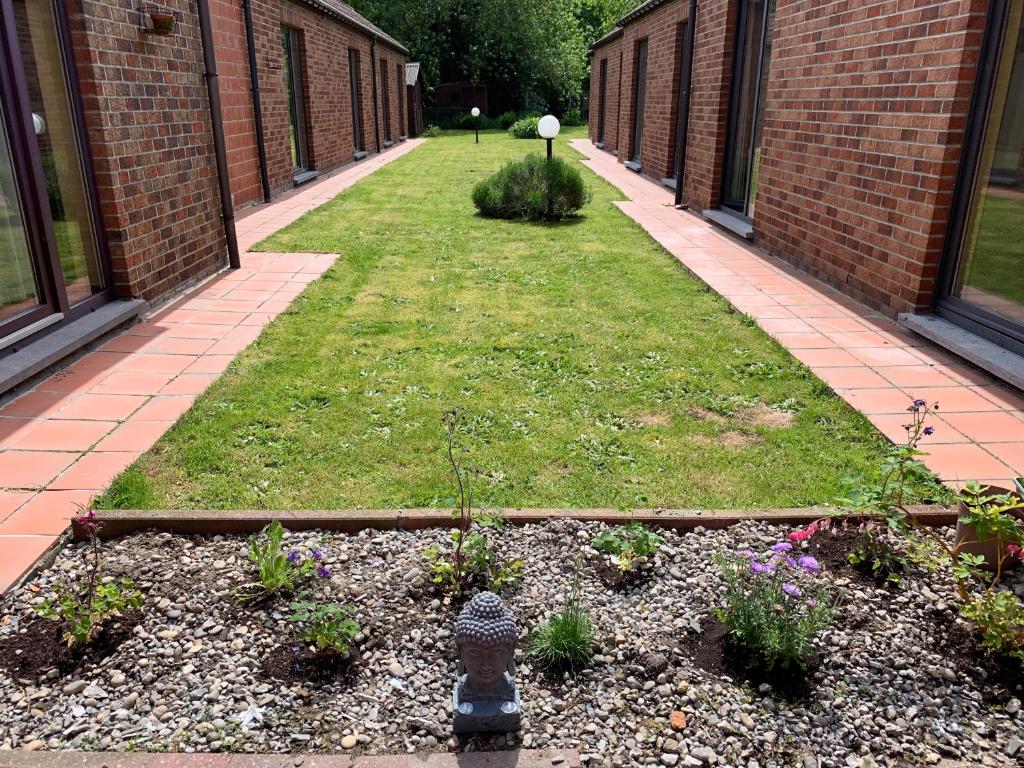 a garden with flowers and a fire hydrant in a courtyard at Carpe Diem in Jumet