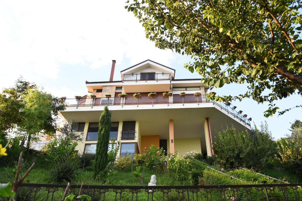 a house with a balcony on top of it at #IoniaHouse Surrel Villa in Tirana