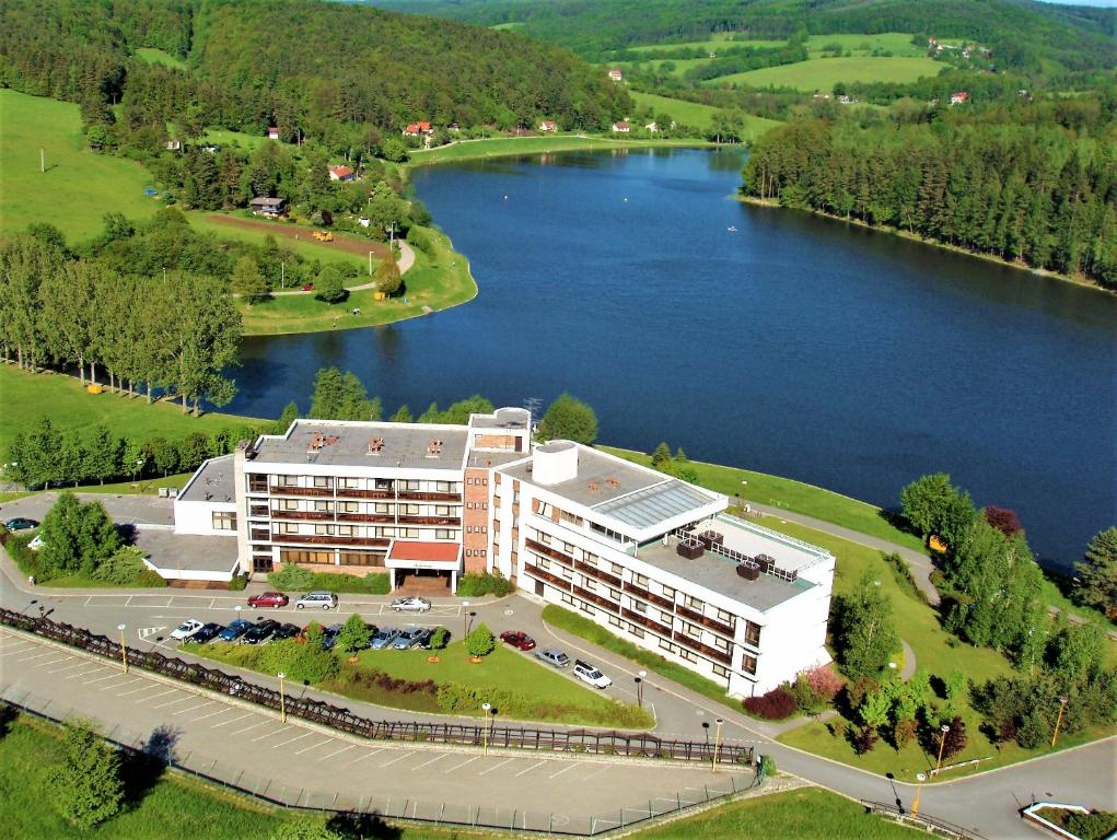 an aerial view of a building next to a river at Hotel Adamantino in Luhačovice