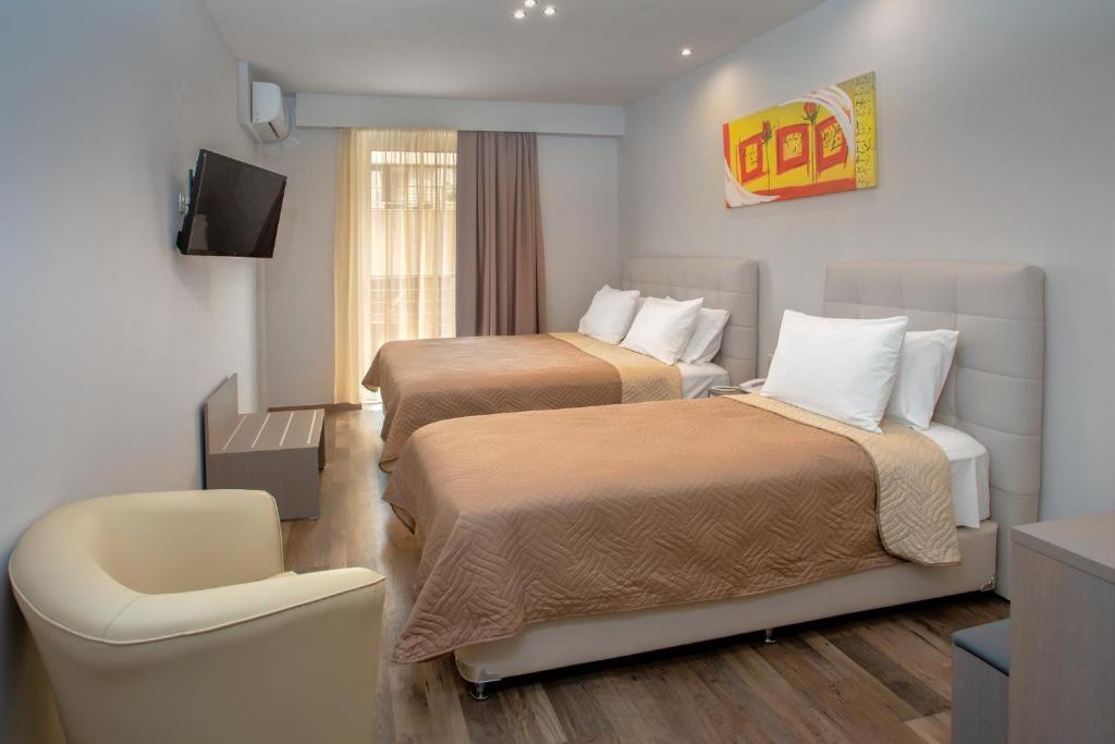 Łóżko lub łóżka w pokoju w obiekcie Irini Hotel